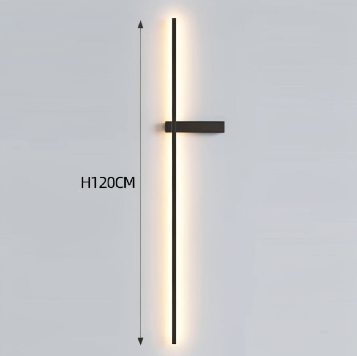 Black minimalist linear LED wall sconce emitting a warm glow, showing 120cm height on a grey background — LivDecor