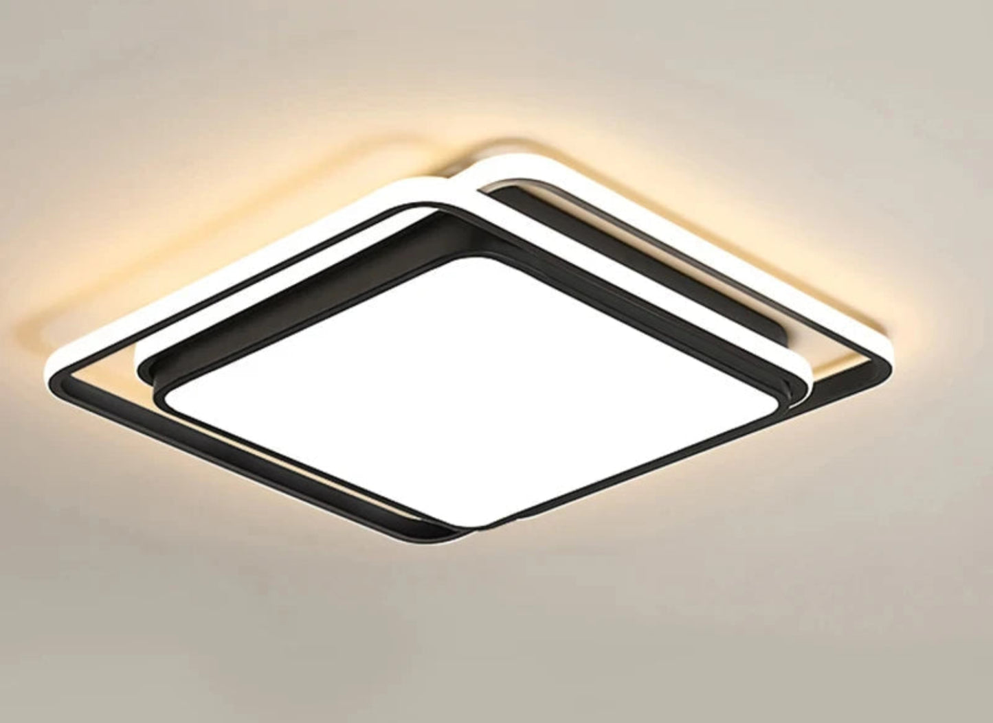 Halo modern tricolor LED flush mount ceiling light in matte black square frame glowing warm white on a white ceiling — LivDecor
