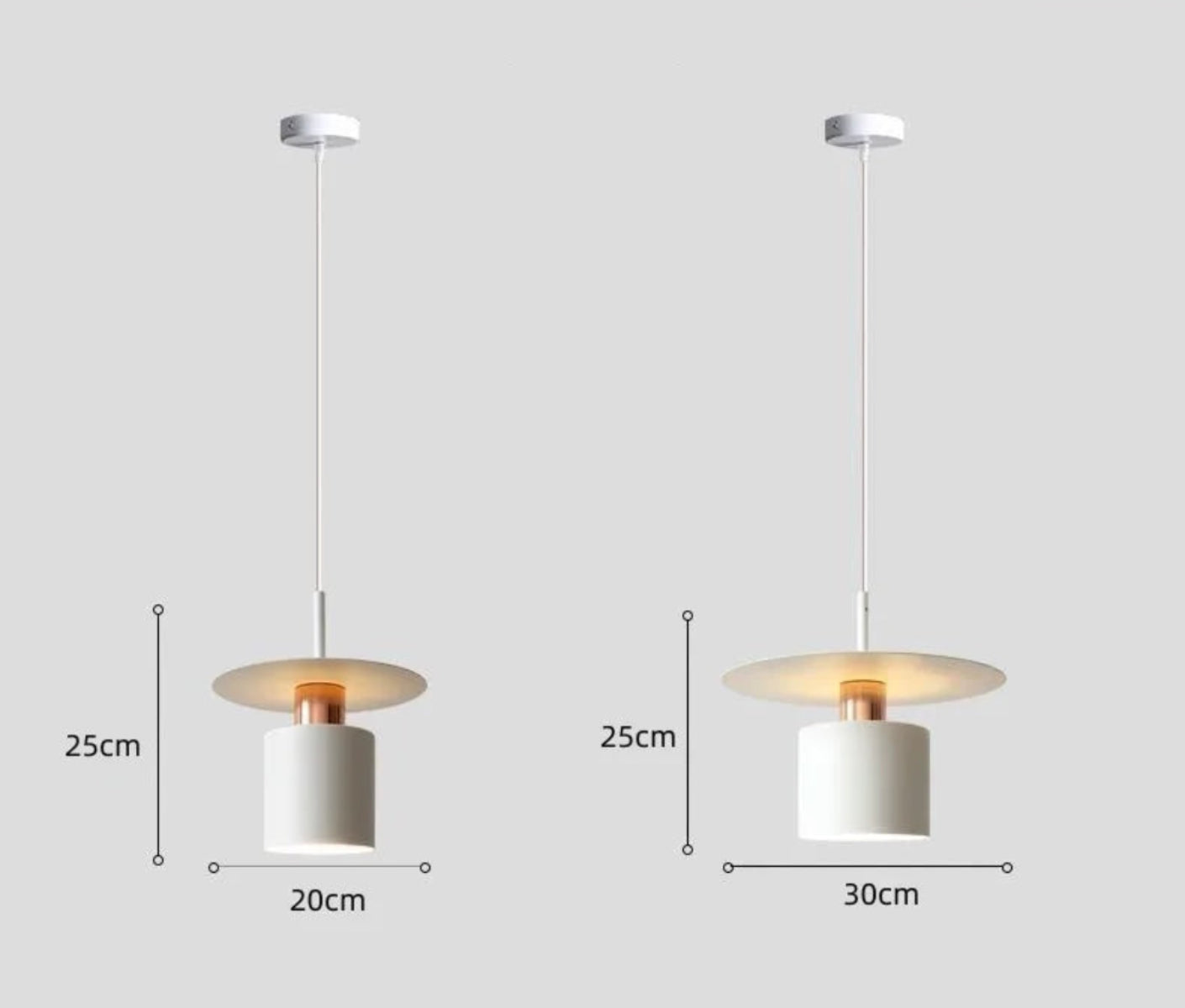 Aero Slim cylinder pendant light in matte white with copper accent side-by-side size comparison showing 20cm and 30cm diameter variants with full cord and ceiling rose on a neutral grey background — LivDecor
