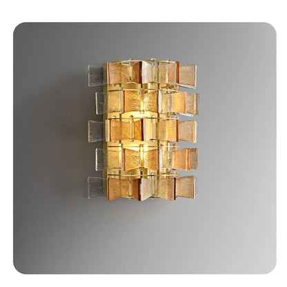 Amber and clear ribbed glass iron wall sconce in large size with four-tier gold frame and glowing bulbs displayed against a neutral grey background — LivDecor
