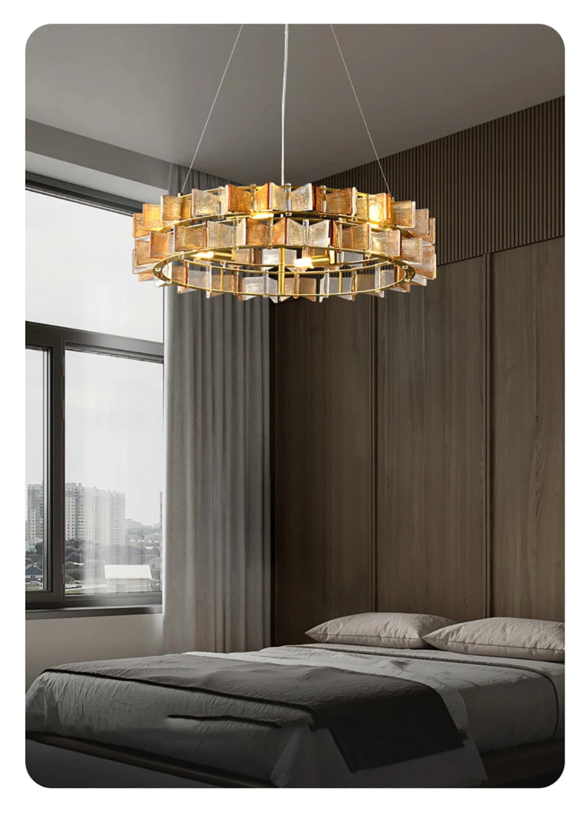 Amber ribbed glass iron round chandelier with gold frame hanging above a modern bed in a contemporary bedroom with floor-to-ceiling windows and city view — LivDecor
