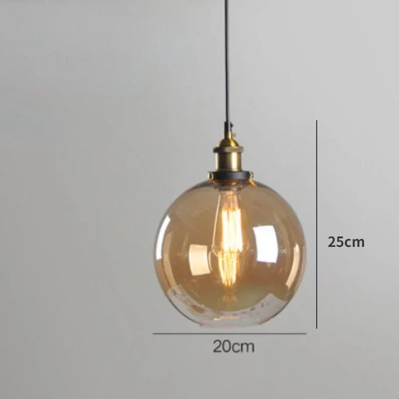 Single amber glass globe pendant light with antique brass socket and Edison filament bulb on black cord, 20cm diameter, 25cm height — LivDecor