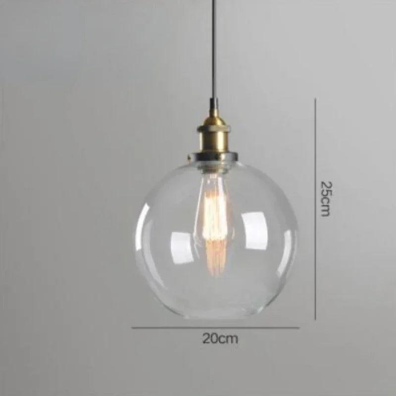Single clear glass globe pendant light with antique brass socket and Edison filament bulb on black cord, 20cm diameter — LivDecor