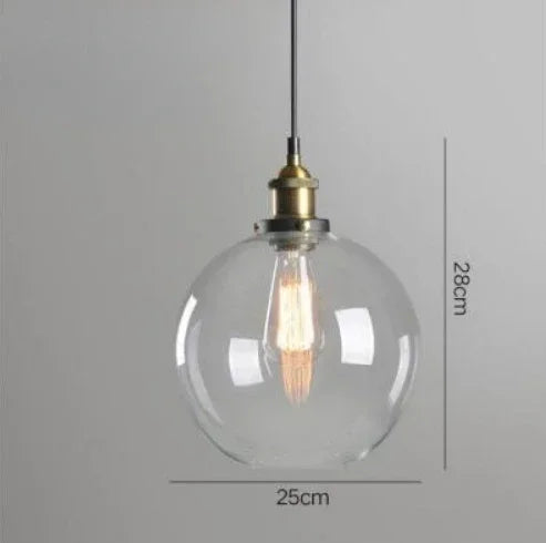 Single clear glass globe pendant light with antique brass socket and Edison filament bulb on black cord, 25cm diameter — LivDecor