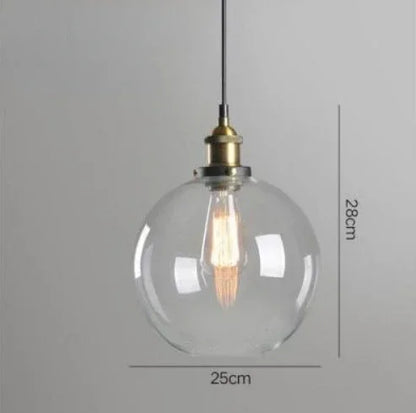 Single clear glass globe pendant light with antique brass socket and Edison filament bulb on black cord, 25cm diameter — LivDecor