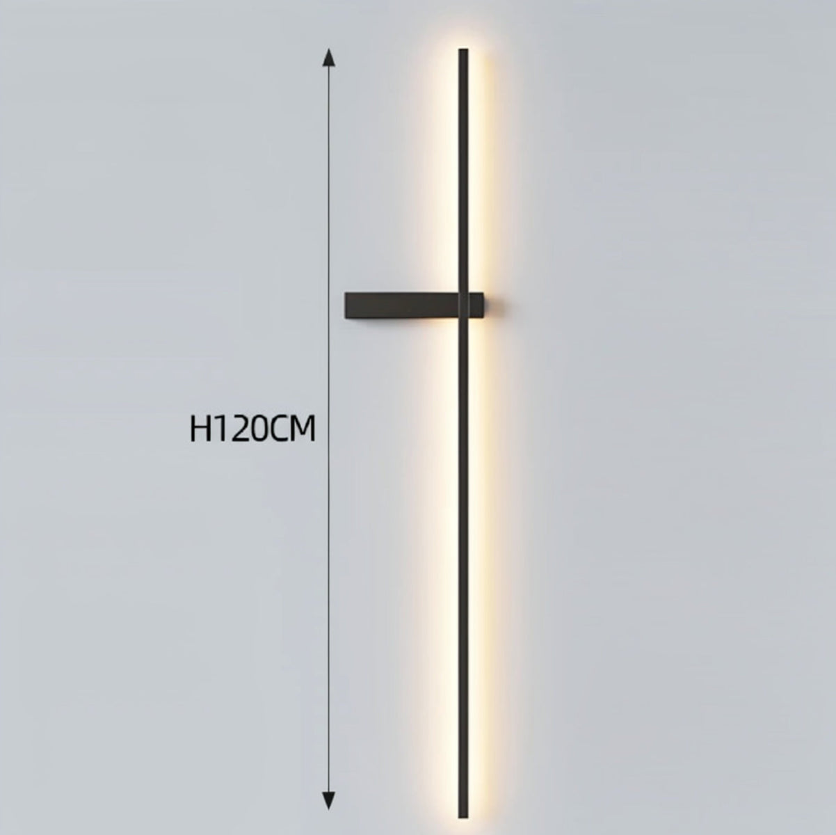 Black minimalist linear LED wall sconce with left-facing mounting arm emitting a warm glow, showing 120cm height on a grey background — LivDecor
