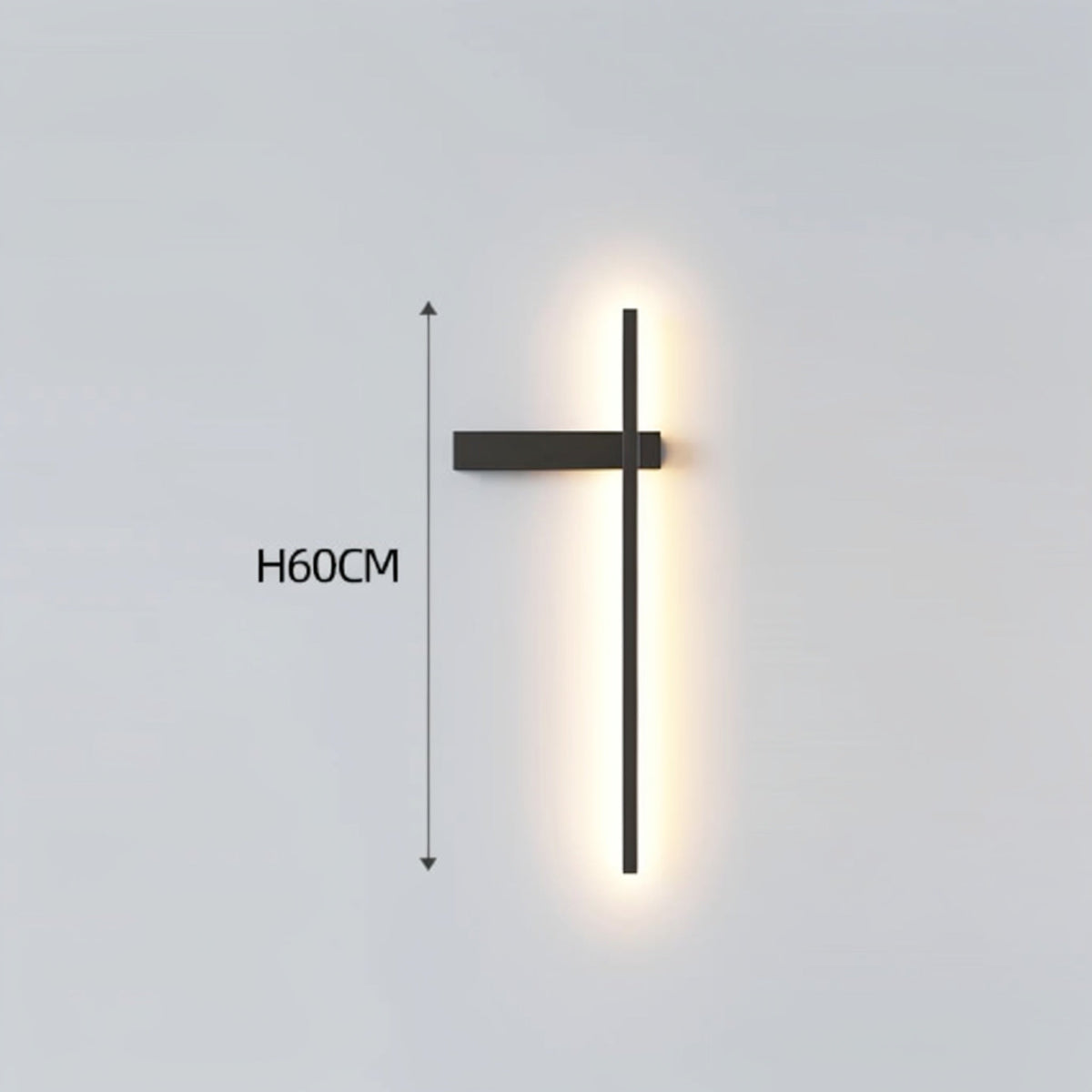 Black minimalist linear LED wall sconce with left-facing mounting arm emitting a warm glow, showing 60cm height on a grey background — LivDecor
