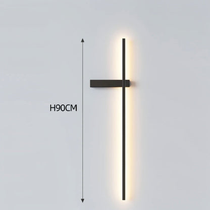 Black minimalist linear LED wall sconce with left-facing mounting arm emitting a warm glow, showing 90cm height on a grey background — LivDecor
