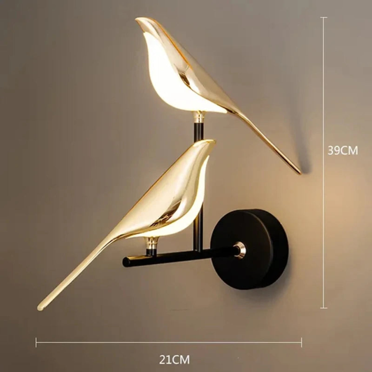 Avis Modern Origami Bird LED wall sconce in gold with matte black arm and round wall plate two-bird configuration illuminated showing dimensions 39cm height by 21cm width on a warm grey wall — LivDecor
