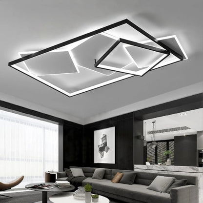 Black geometric multi-rectangle LED flush mount ceiling light illuminated above a dark open-plan living and dining room with grey sofas — LivDecor
