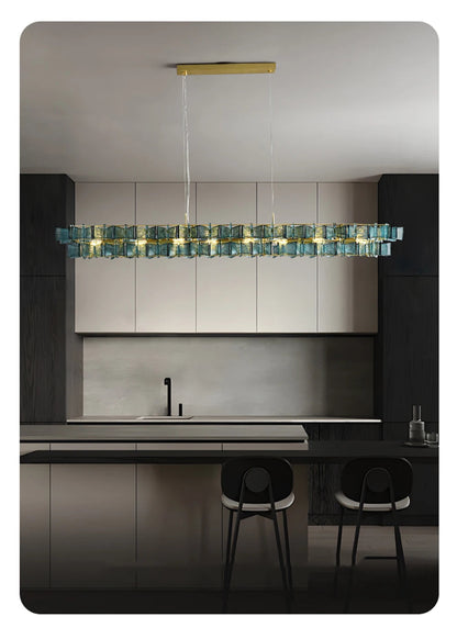 Blue ribbed glass iron linear chandelier with gold rectangular ceiling mount hanging above a dark modern kitchen island with bar stools — LivDecor