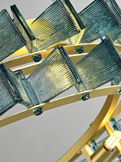 Close-up of blue ribbed glass panels and brushed gold double-ring frame of the round chandelier showing fine ribbed texture and hardware construction — LivDecor