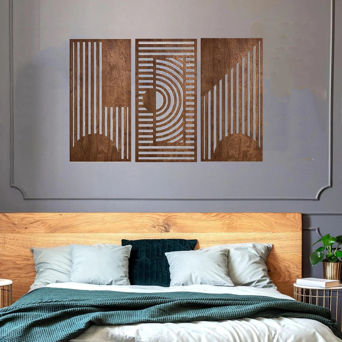 3-piece boho geometric laser-cut wooden wall art set in walnut finish displayed above a wooden headboard in a modern bedroom with teal bedding and grey panelled walls — LivDecor