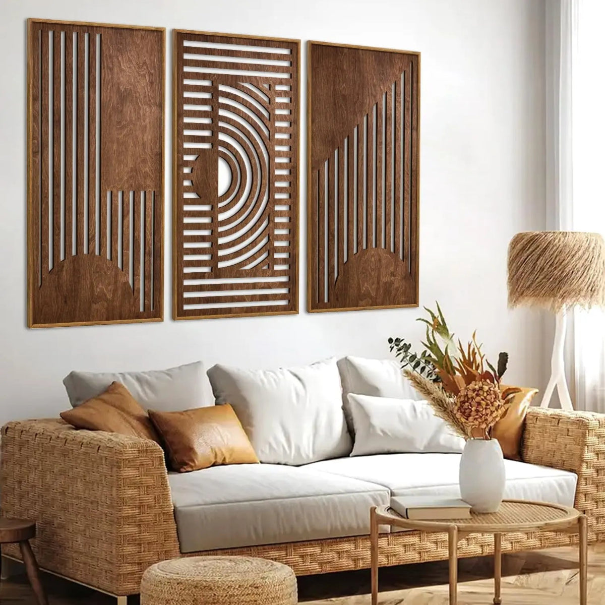 3-piece boho geometric laser-cut wooden wall art set in walnut finish displayed above a rattan sofa with cream cushions and dried floral arrangement in a bright boho living room — LivDecor
