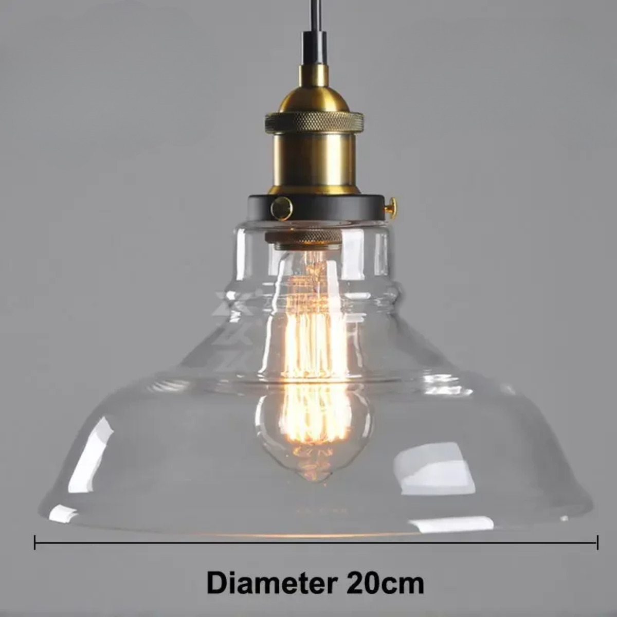 Clear glass dome pendant light with brass Edison fitting and lit filament bulb, showing 20cm diameter on a grey background — LivDecor
