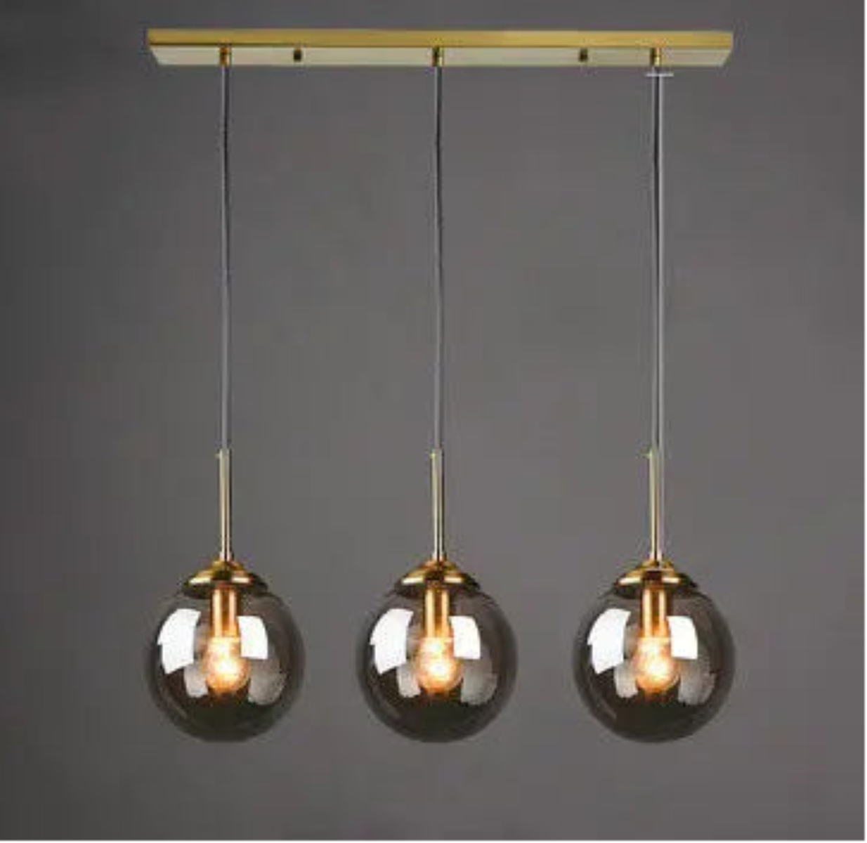 Five clear glass globe pendant lights on staggered gold cords and round ceiling mount in a spiral cluster configuration — LivDecor