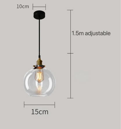 Clear glass globe pendant light with brass Edison bulb fitting and black cord, showing 15cm diameter with 1.5m adjustable cord on a grey background — LivDecor