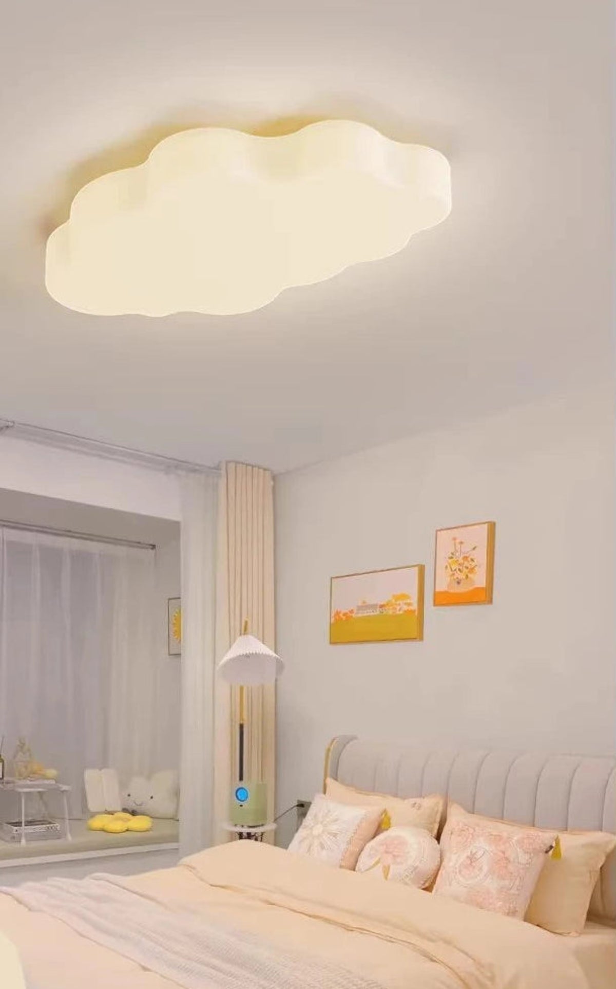 Cumulus Luxe cream sculptural single cloud LED ceiling light without halo ring glowing soft warm white in a kids bedroom with peach bedding, yellow wall art, and a floor lamp — LivDecor
