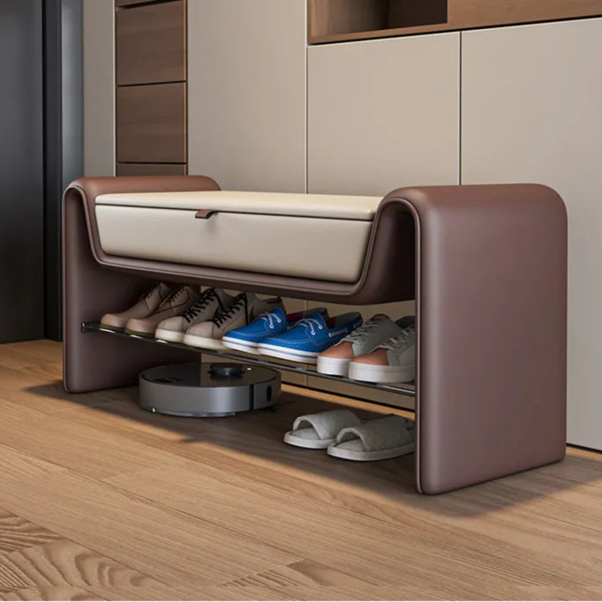Entryway shoe storage bench in chocolate brown leather with rounded legs, cream linen flip-top seat cushion, and two-tier chrome shoe rack styled on oak flooring with taupe cabinetry — LivDecor
