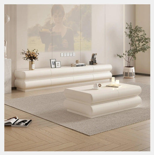 Cream ivory tubular floating TV stand and matching coffee table set styled in a spacious modern living room with an olive tree, dried florals, and herringbone wood floor lifestyle shot — LivDecor
