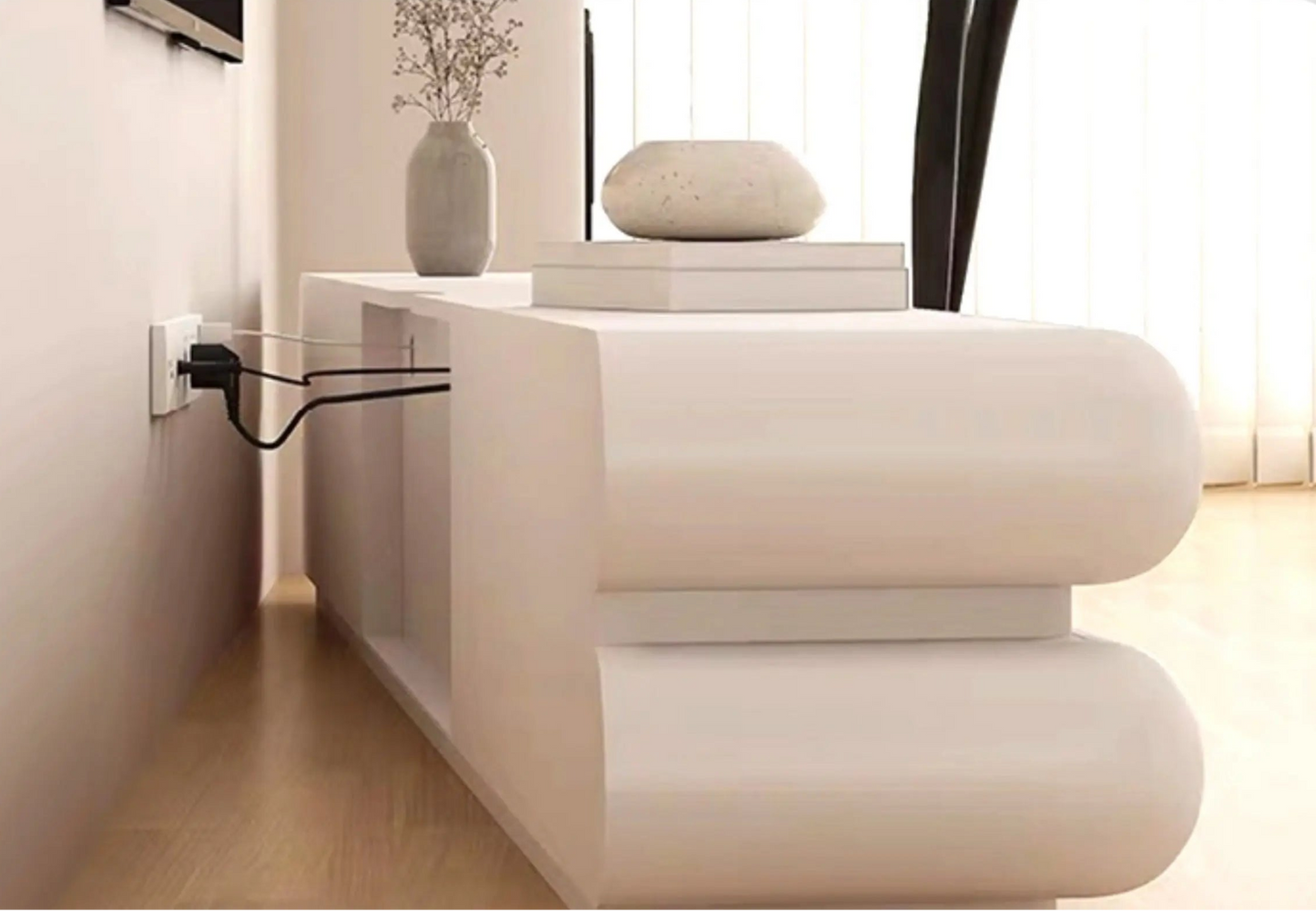 Side angle close-up of a cream ivory tubular floating TV stand wall-mounted with power cord visible beside a grey ceramic vase in a bright minimalist living room lifestyle shot — LivDecor
