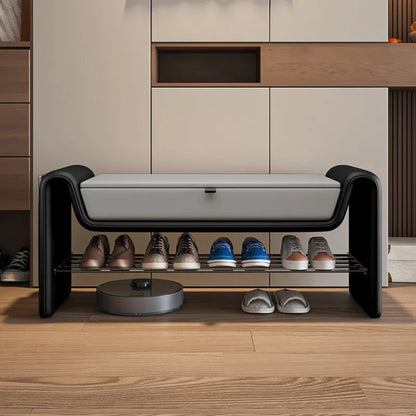 Folio Luxe entryway shoe storage bench in black faux leather with grey lift-top seat shown straight-on with shoes organized on the lower rack in a modern entryway — LivDecor
