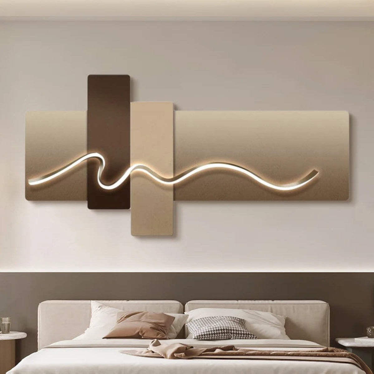 Geometric Wave LED wall art with champagne and dark mocha cross-panel canvas and sinuous chrome LED light strip illuminated above a taupe upholstered bed with tonal linen bedding — LivDecor

