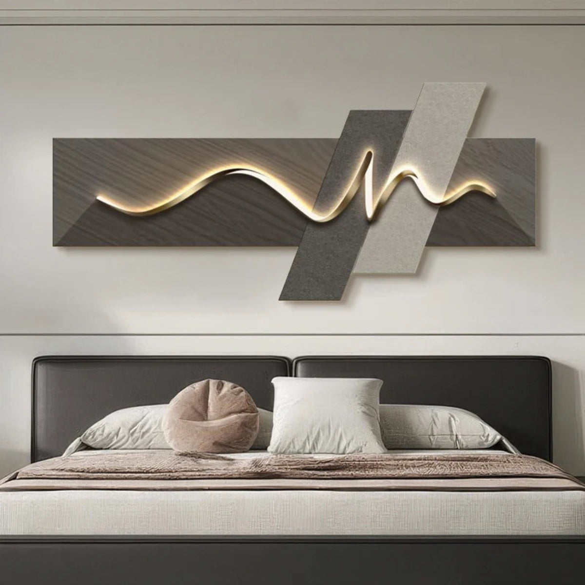 Geometric Wave LED wall art with dark walnut and silver-grey diagonal slash cross-panel canvas and warm amber LED light strip illuminated above a charcoal leather bed frame with cream and blush linen bedding — LivDecor
