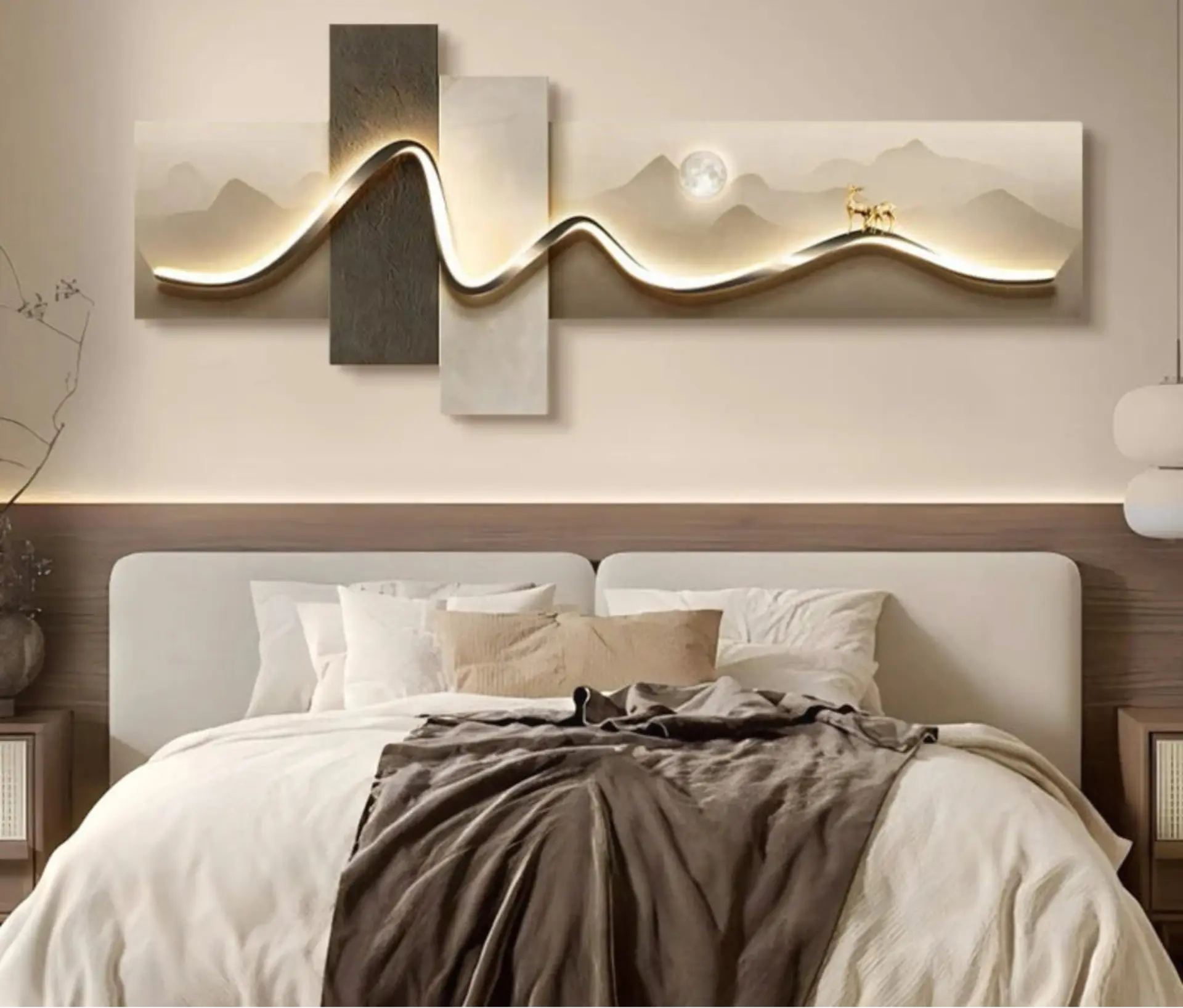 Geometric wave LED wall art with an illuminated gold ribbon over a mountain and moon landscape with a golden deer, mounted above a bed in a neutral bedroom — LivDecor
