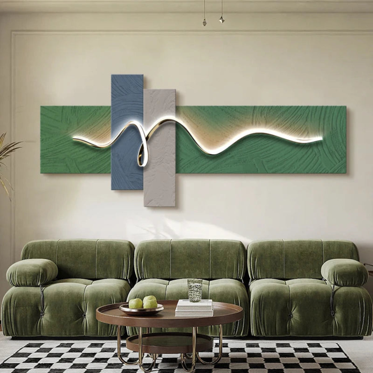 Geometric Wave LED wall art with sage green and slate blue cross-panel canvas and sinuous chrome LED light strip illuminated above a deep olive green modular sofa with walnut round coffee table — LivDecor
