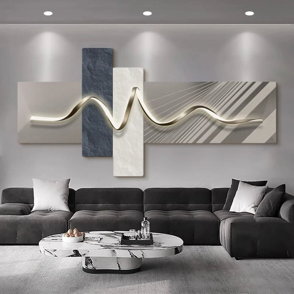 Geometric Wave LED wall art with slate blue marble and cream diagonal line-texture cross-panel canvas and warm gold LED light strip illuminated above a charcoal velvet L-shaped sectional with white marble oval coffee table — LivDecor
