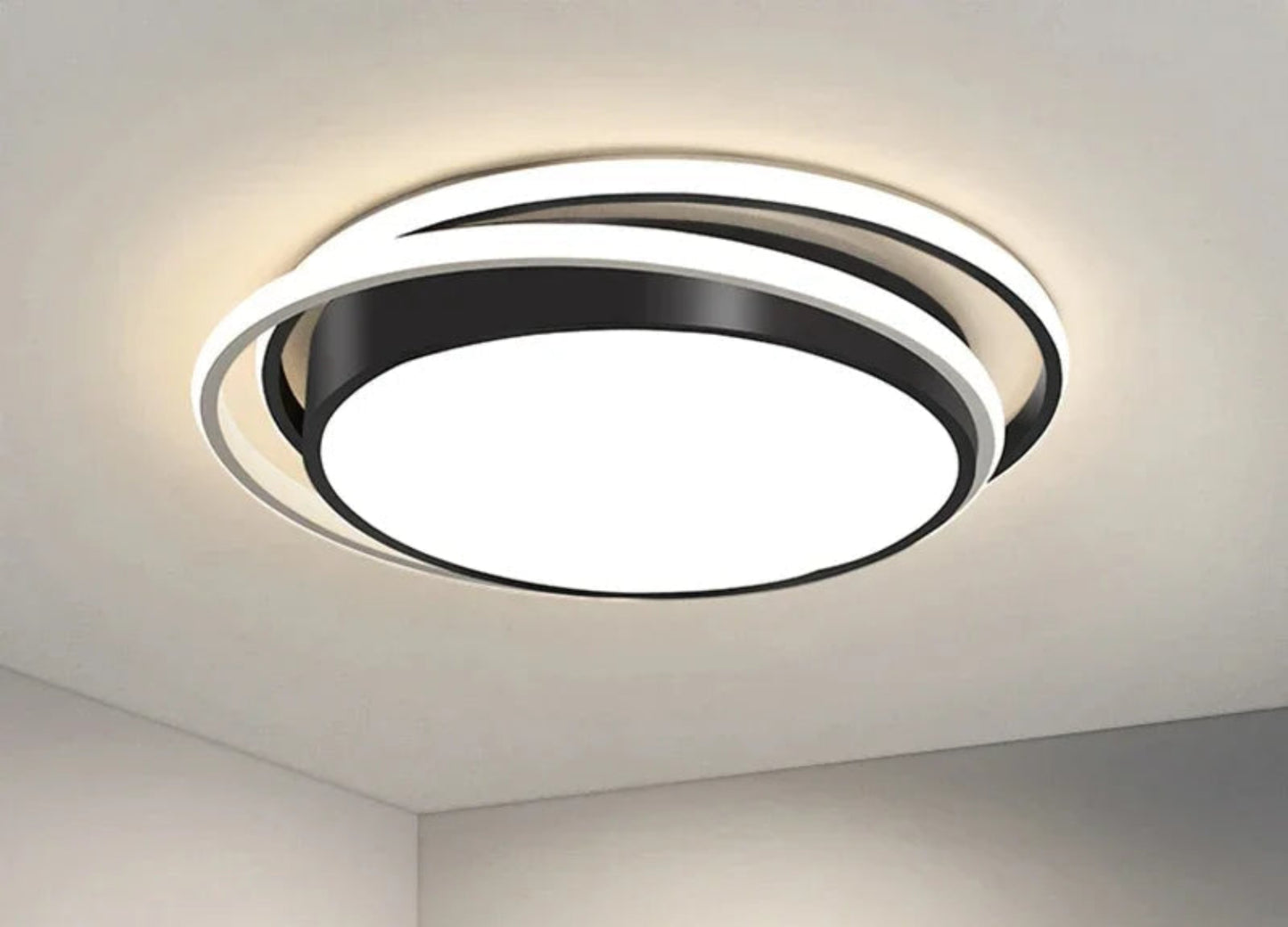 Halo modern tricolor LED flush mount ceiling light in matte black round double-ring frame glowing cool white on a white ceiling corner — LivDecor
