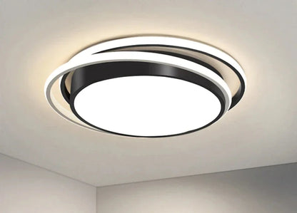 Halo modern tricolor LED flush mount ceiling light in matte black round double-ring frame glowing cool white on a white ceiling corner — LivDecor
