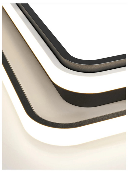 Extreme close-up macro detail of the Halo LED flush mount ceiling light showing layered matte black and white acrylic ring construction with soft LED glow — LivDecor
