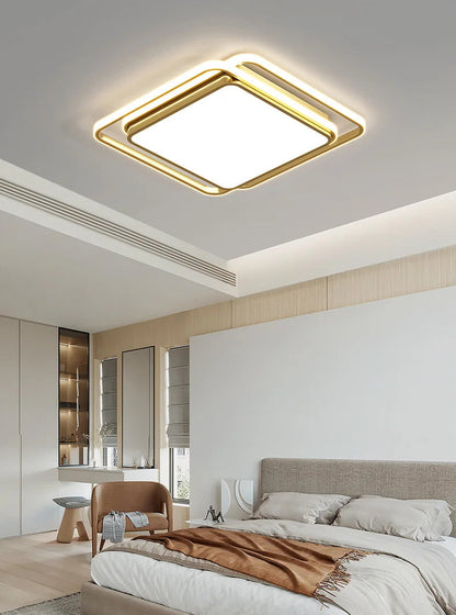 Halo modern tricolor LED flush mount ceiling light in golden square frame glowing warm white installed in a Japandi-style bedroom with linen bedding, neutral tones, and natural window light — LivDecor

