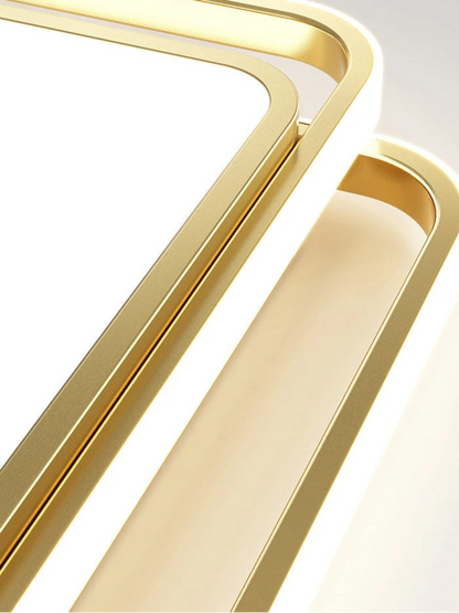 Extreme close-up macro detail of the Halo LED flush mount ceiling light showing brushed gold metal square frame and rounded corner construction with soft LED glow — LivDecor

