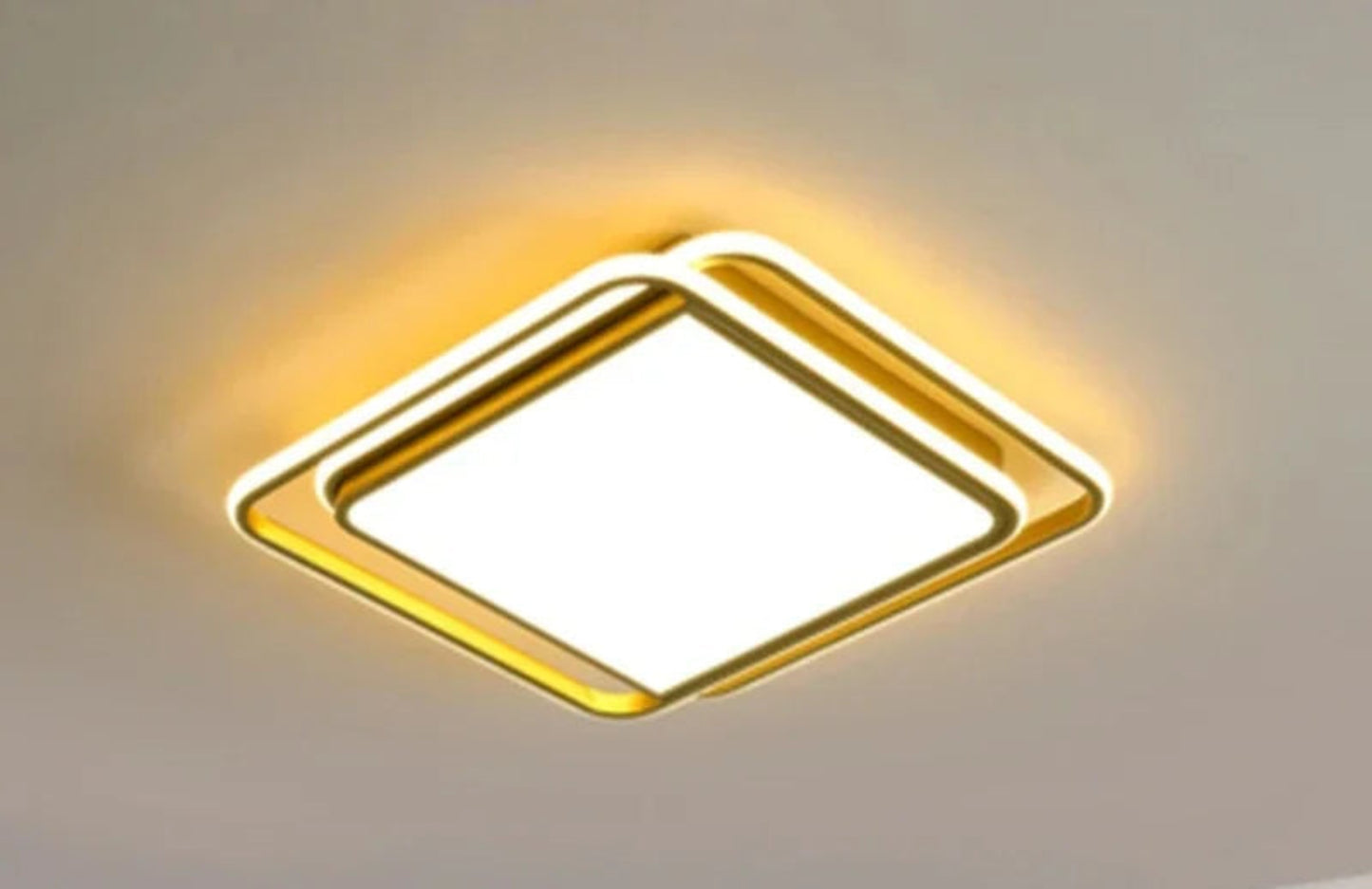 Halo modern tricolor LED flush mount ceiling light in golden square frame glowing warm amber on a white ceiling — LivDecor
