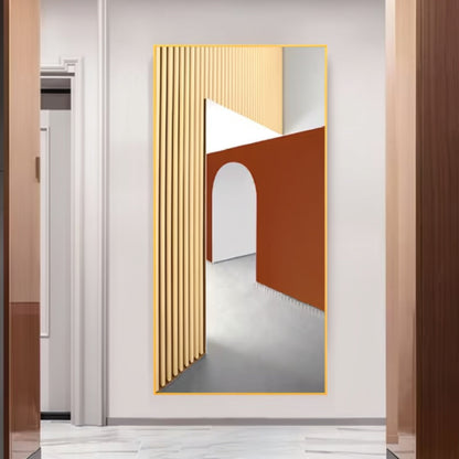 Gold-framed vertical mural of a warm minimalist architectural scene with fluted cream columns, a terracotta wall and an arched corridor, mounted in a hallway entryway — LivDecor
