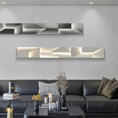 Luminary Canvas backlit crystal art wall sconce in horizontal configuration shown in grey and white warm LED tones mounted above a dark leather sofa in a modern living room — LivDecor
