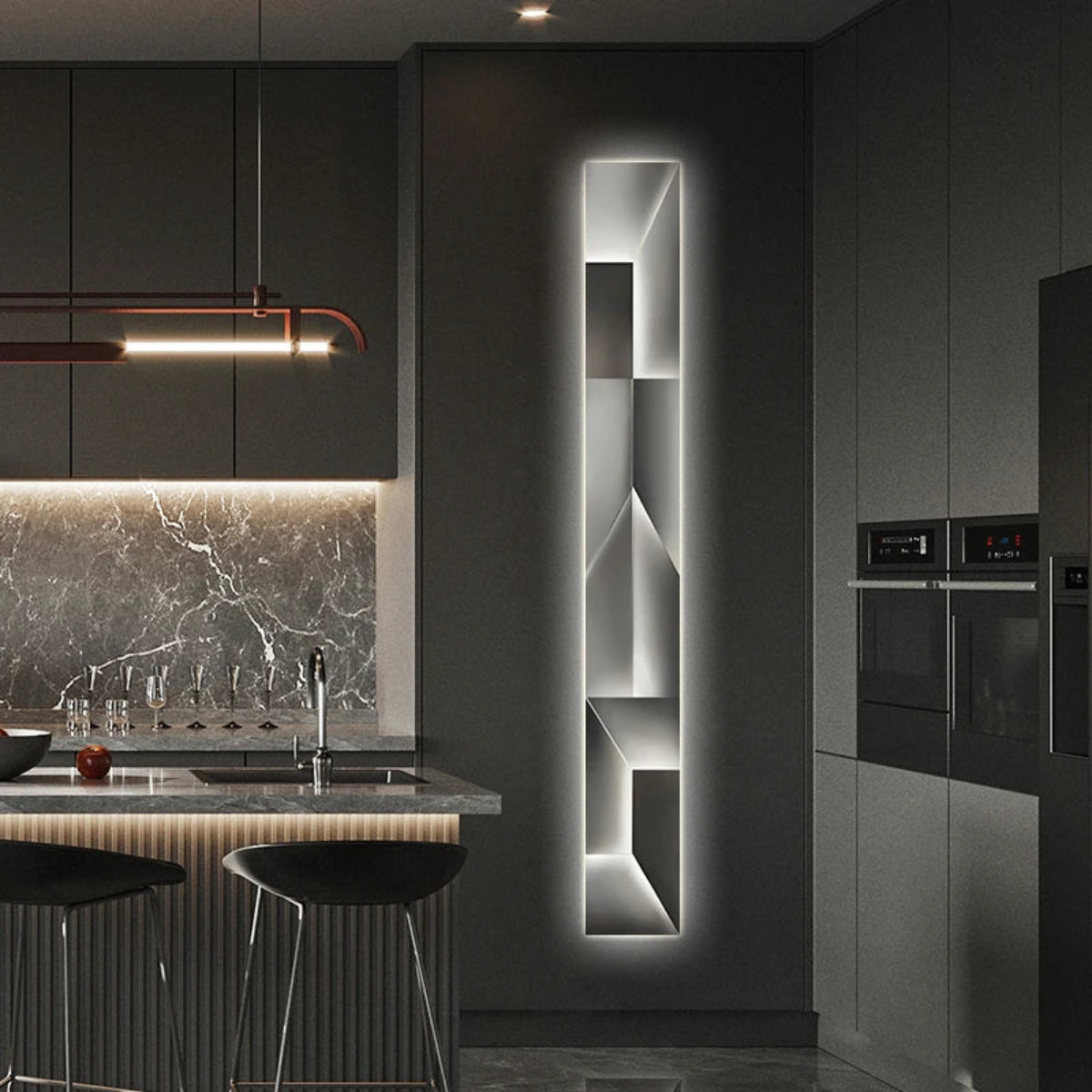 Luminary Canvas backlit crystal art wall sconce in vertical configuration with cool white LED glow mounted in a dark luxury kitchen with marble backsplash and matte black cabinetry — LivDecor
