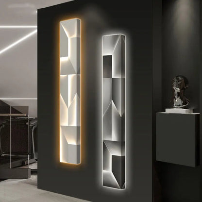 Luminary Canvas backlit crystal art wall sconce shown in vertical configuration side by side in warm and cool LED tones against a dark gallery wall with sculptural bust — LivDecor

