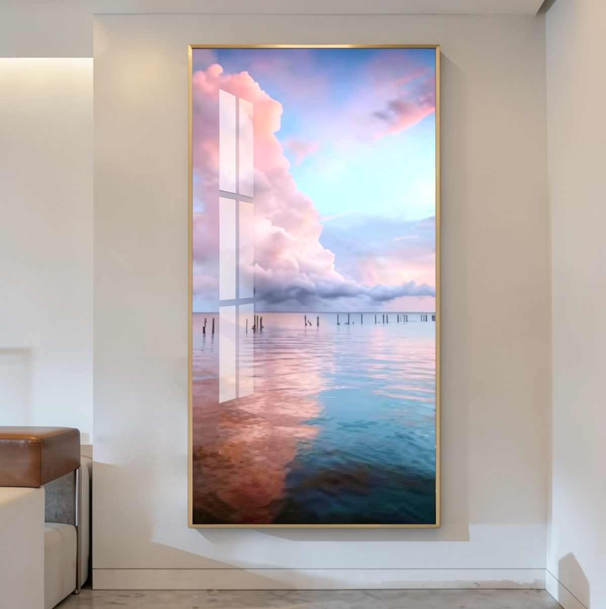 Gold-framed vertical mural of a dreamy pastel seascape with soft pink and blue dusk clouds reflected over calm water, mounted in a neutral entryway beside a leather bench — LivDecor
