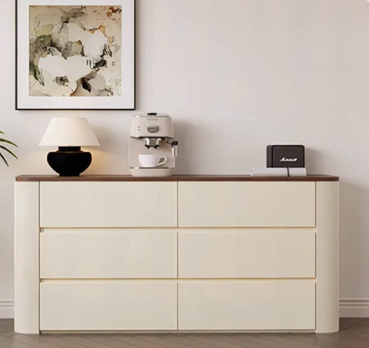 Nordic Elegance cream six-drawer credenza with walnut top and rounded ends shown front-on, styled with a lamp, espresso machine, Marshall speaker and framed abstract art — LivDecor
