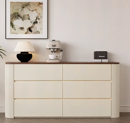 Nordic Elegance cream six-drawer credenza with walnut top and rounded ends shown front-on, styled with a lamp, espresso machine, Marshall speaker and framed abstract art — LivDecor
