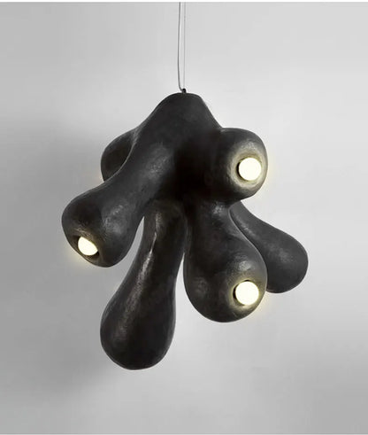 Odense Cocoon sculptural cloud pendant chandelier in black with 4-head organic cluster fully lit with warm glow on a neutral grey background — LivDecor
