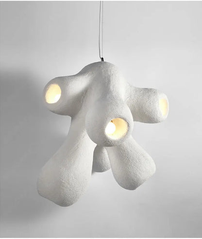 Odense Cocoon sculptural cloud pendant chandelier in white with 4-head organic cluster fully lit with warm glow showing textured plaster-like finish on a neutral grey background — LivDecor
