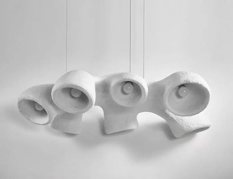 Odense Cocoon sculptural cloud pendant chandelier in white with 4 individual downward-facing open cavity pendants hung in a linear row on separate cords against a neutral white background — LivDecor
