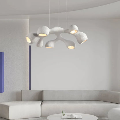Odense Cocoon sculptural cloud pendant chandelier in white 7-head flat configuration hanging in an all-white minimalist living room with curved grey sectional sofa and round coffee table — LivDecor
