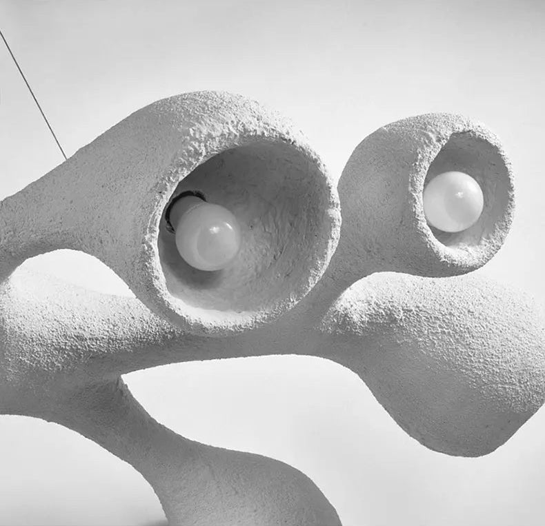 Odense Cocoon sculptural cloud pendant chandelier black and white close-up of two recessed bulb cavities showing rough textured plaster-like surface and organic sculptural form — LivDecor
