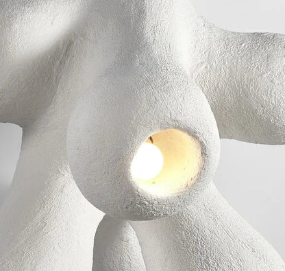 Odense Cocoon sculptural cloud pendant chandelier close-up of single lit cavity with warm glow surrounded by organic branching white textured arms — LivDecor
